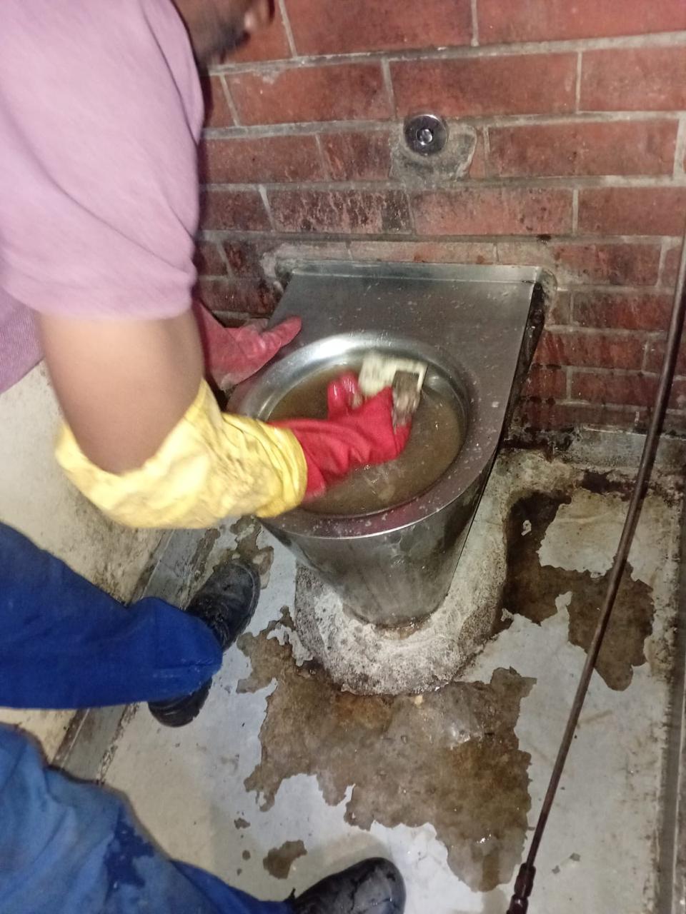 Plumber clearing an external drain blockage